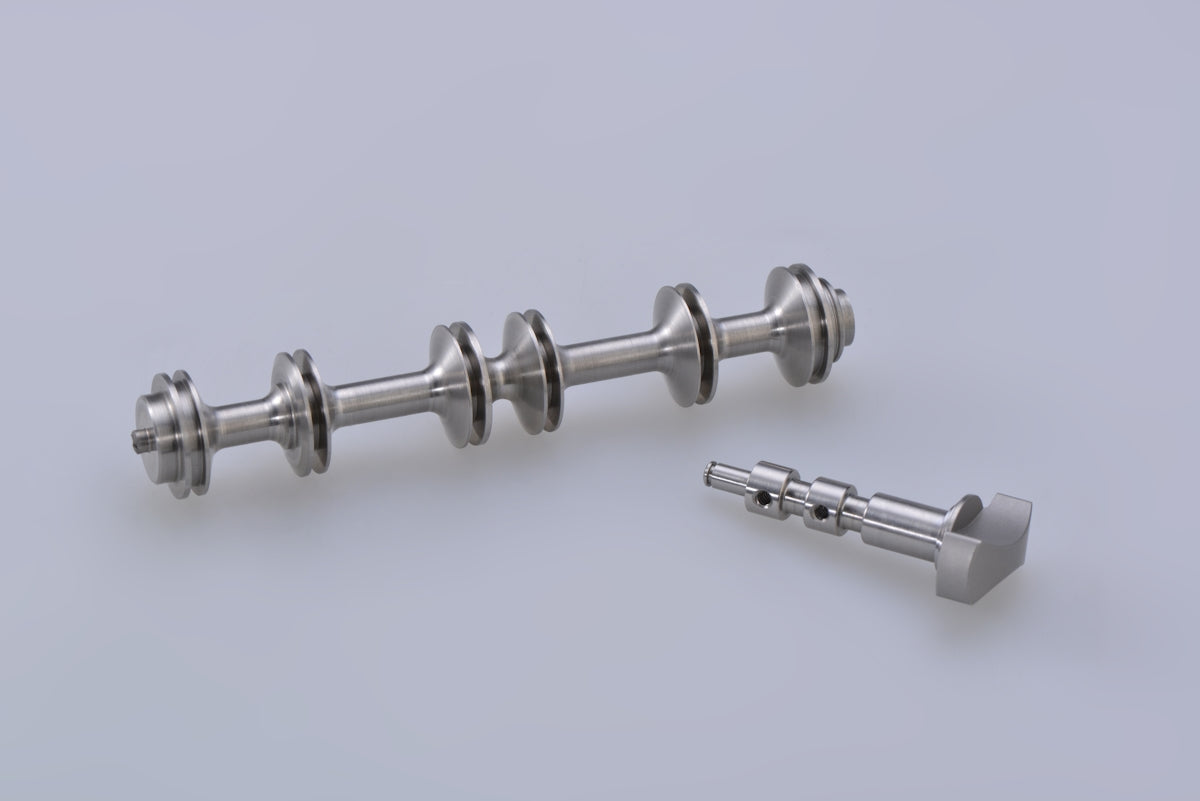 silver steel dumbbell on white surface